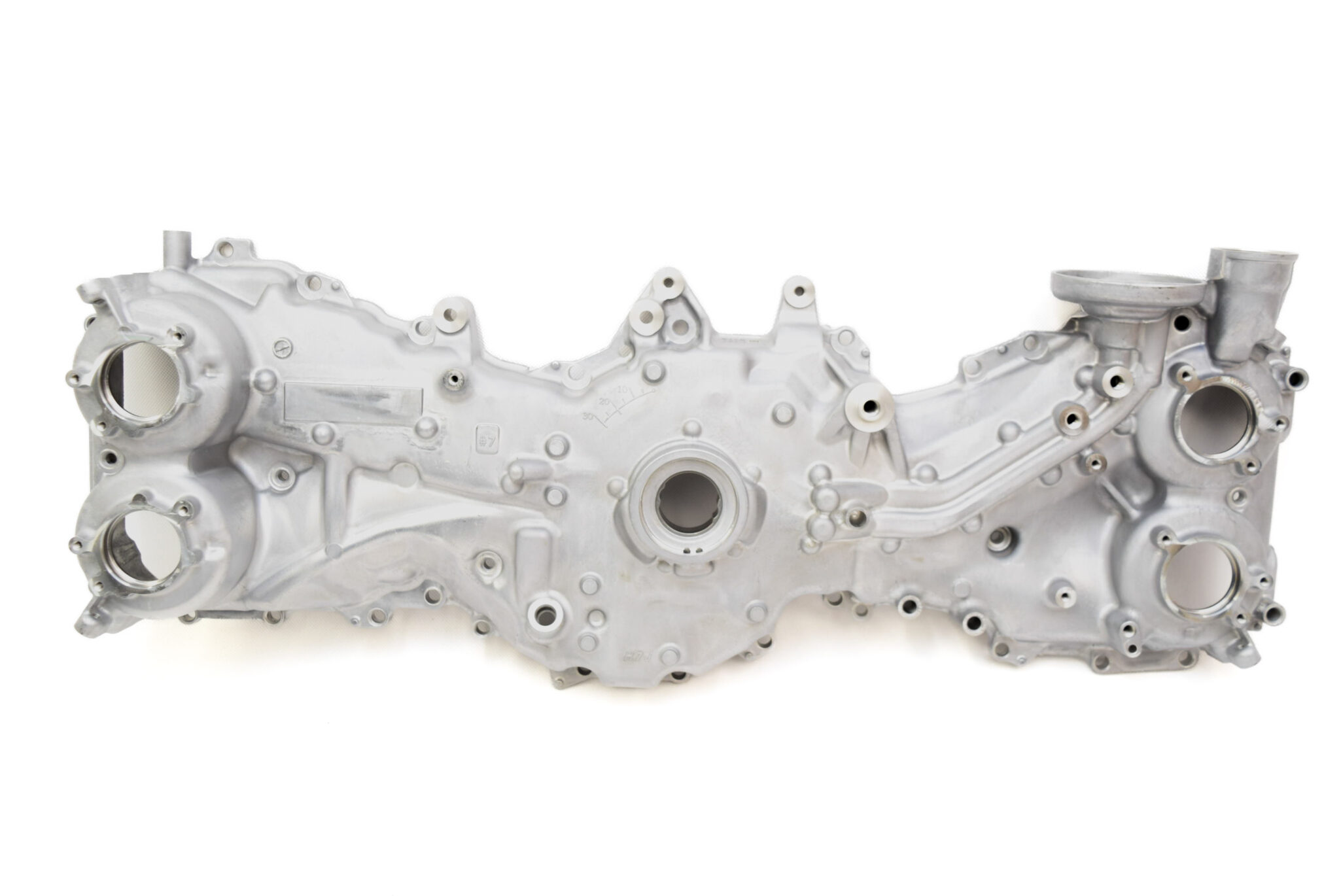 Aluminum automotive engine block with multiple circular bores and mounting points against a white background.